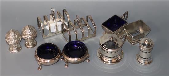 A pair of George V silver toast racks, Sheffield, 1934 and seven assorted silver condiments including Georgian.
